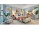 Comfortable bedroom features soft blue walls, carpet, neutral furniture and plenty of natural light at 12636 Hammock Pointe Cir, Clermont, FL 34711