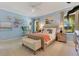 Comfortable bedroom features soft blue walls, carpet, neutral furniture and plenty of natural light at 12636 Hammock Pointe Cir, Clermont, FL 34711