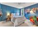 Cozy bedroom with a queen size bed, with stylish blue wall paneling at 12636 Hammock Pointe Cir, Clermont, FL 34711