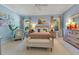 Comfortable bedroom features soft blue walls, carpet, neutral furniture and plenty of natural light at 12636 Hammock Pointe Cir, Clermont, FL 34711
