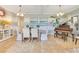 Dining room featuring tile floors, striped walls, and a dining table with decorative chairs and a piano at 12636 Hammock Pointe Cir, Clermont, FL 34711