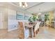Bright dining room with gray accent walls, tile flooring, and beach-themed artwork at 12636 Hammock Pointe Cir, Clermont, FL 34711