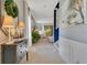 Hallway with beach artwork, decorative furniture, and view into the living space at 12636 Hammock Pointe Cir, Clermont, FL 34711