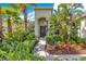 Charming front entrance with lush landscaping and inviting walkway to the front door at 12636 Hammock Pointe Cir, Clermont, FL 34711