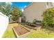 Home's garden area features raised garden beds and a bench for enjoying the serene outdoor space at 12636 Hammock Pointe Cir, Clermont, FL 34711
