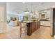 Bright open floor plan, kitchen with white cabinets and island connected to the living room at 12636 Hammock Pointe Cir, Clermont, FL 34711