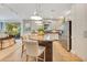 Spacious kitchen with an island, barstool seating, stainless appliances, and views of the backyard at 12636 Hammock Pointe Cir, Clermont, FL 34711