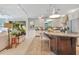 Open kitchen featuring an island with seating, stainless steel appliances, and ample cabinet space at 12636 Hammock Pointe Cir, Clermont, FL 34711