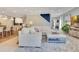 Bright, open-concept living space with an area rug and white sofa at 12636 Hammock Pointe Cir, Clermont, FL 34711