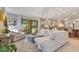 Open-concept living room with white sofas and a large sliding glass door to the outside at 12636 Hammock Pointe Cir, Clermont, FL 34711