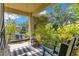 Inviting covered patio with a porch swing, seating area, and lush landscaping at 12636 Hammock Pointe Cir, Clermont, FL 34711