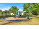 Community playground with a slide, climbing structure, bench seating and a trash can at 12636 Hammock Pointe Cir, Clermont, FL 34711