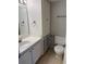 A well-lit bathroom with a vanity, mirror, toilet, and built in storage at 131 Water Front Way # 110, Altamonte Springs, FL 32701