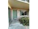 Inviting entryway with a charming green door, matching shutters, and a well-maintained garden at 131 Water Front Way # 110, Altamonte Springs, FL 32701