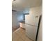 Well-lit kitchen with full-size refrigerator, countertop, and ample cabinet space at 131 Water Front Way # 110, Altamonte Springs, FL 32701