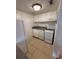 Clean kitchen features white cabinetry, tile backsplash, and modern appliances at 131 Water Front Way # 110, Altamonte Springs, FL 32701