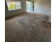Comfortable living room with neutral carpet, a window, and a view of the front door and entrance at 131 Water Front Way # 110, Altamonte Springs, FL 32701