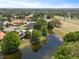 Beautiful aerial view showcasing a golf course community with ponds, trees, and well-manicured lawns at 14037 Fairway Willow Ln, Winter Garden, FL 34787
