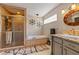Bright bathroom featuring a soaking tub with mosaic tile and a glass-enclosed shower with modern fixtures at 14037 Fairway Willow Ln, Winter Garden, FL 34787
