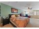 Large primary bedroom featuring neutral carpet, a decorative bedspread, and a dedicated office space at 14037 Fairway Willow Ln, Winter Garden, FL 34787