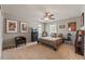 Bedroom featuring a queen bed, carpeted floor, ceiling fan, and decorative wall art at 14037 Fairway Willow Ln, Winter Garden, FL 34787