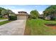 Charming home featuring well-maintained landscaping, a two-car garage, and a concrete driveway at 14037 Fairway Willow Ln, Winter Garden, FL 34787