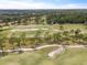 Scenic aerial view of the golf course highlighting manicured greens, sand traps, and mature trees at 14037 Fairway Willow Ln, Winter Garden, FL 34787