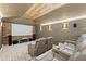 Home theater room with a large screen, recliner seating, and stone accents at 14037 Fairway Willow Ln, Winter Garden, FL 34787