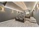 Home theater with tiered seating, sconce lighting, and a wood-paneled ceiling at 14037 Fairway Willow Ln, Winter Garden, FL 34787
