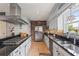 Modern kitchen featuring stainless steel appliances, granite countertops, and a stylish backsplash at 14037 Fairway Willow Ln, Winter Garden, FL 34787