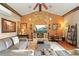 Spacious living area featuring a vaulted ceiling, stone fireplace, and hardwood floors at 14037 Fairway Willow Ln, Winter Garden, FL 34787