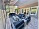 Relaxing outdoor patio featuring a seating area, fire pit, and screened enclosure for comfortable living at 14037 Fairway Willow Ln, Winter Garden, FL 34787