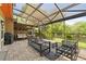 Covered patio with comfortable seating, a swing and views of the backyard, perfect for outdoor relaxation at 14037 Fairway Willow Ln, Winter Garden, FL 34787