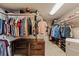 Walk-in closet with ample storage and organization, featuring shelving, drawers, and hanging space at 14037 Fairway Willow Ln, Winter Garden, FL 34787