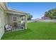 Expansive backyard featuring a covered patio, lush green lawn, and a privacy fence, perfect for outdoor living at 14137 Queenside St, Orlando, FL 32824