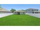 Large, fenced backyard with a green lawn, providing ample space for recreation and outdoor enjoyment at 14137 Queenside St, Orlando, FL 32824