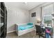 Bedroom featuring a twin bed with under-bed storage, carpeted floors, a desk, and natural light at 14137 Queenside St, Orlando, FL 32824