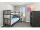 Bedroom with bunk beds, carpeted floors, a window with blinds, and a dark dresser with drawers at 14137 Queenside St, Orlando, FL 32824