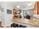 Bright kitchen features granite countertops, stainless steel appliances, and a breakfast bar with seating at 14137 Queenside St, Orlando, FL 32824