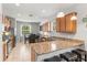 Bright kitchen with granite countertops, ample cabinet space, and a view of the dining area at 14137 Queenside St, Orlando, FL 32824