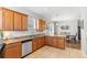 Open kitchen boasts granite countertops, stainless steel appliances, and ample cabinet space at 14137 Queenside St, Orlando, FL 32824