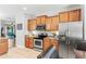 Well-equipped kitchen with stainless steel appliances, granite counters and wooden cabinetry at 14137 Queenside St, Orlando, FL 32824