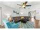 Cozy living room with comfortable seating, a ceiling fan, and a view of the backyard at 14137 Queenside St, Orlando, FL 32824