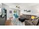 Cozy living room featuring a comfortable leather sofa, plush armchair, and a bright area rug at 14137 Queenside St, Orlando, FL 32824