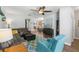 Open-concept living room with comfortable furnishings, leading into the kitchen and dining areas at 14137 Queenside St, Orlando, FL 32824
