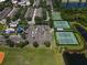 Aerial view of community amenities including a playground, parking, baseball field and tennis and basketball courts near a pond at 14262 Tanja King Blvd, Orlando, FL 32828