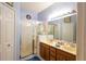 Bathroom with a glass enclosed shower, double sink vanity, and well lit mirror at 14262 Tanja King Blvd, Orlando, FL 32828