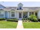 Charming single-story townhome featuring a well-manicured lawn and inviting front porch area at 14262 Tanja King Blvd, Orlando, FL 32828