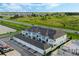 Wide aerial perspective of a new townhouse complex surrounded by lush greenery, roads, and recreational areas at 15201 Summer Harvest St, Winter Garden, FL 34787