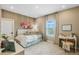 Charming bedroom with a plush bed, decorative floral accents, and a functional workspace by the window at 15201 Summer Harvest St, Winter Garden, FL 34787
